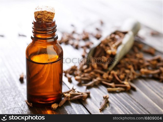 clove oil in glass bottles and on a table