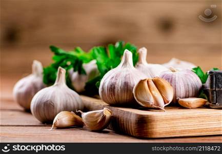 Cloves of fresh garlic on the table. On a wooden background. High quality photo. Cloves of fresh garlic on the table.