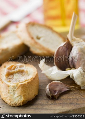 Cloves of Roasted Garlic spread on Toasted baguette