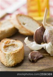 Cloves of Roasted Garlic spread on Toasted baguette