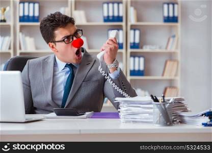 Clown businessman angry frustrated working in the office