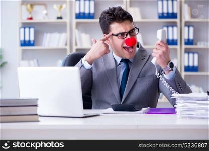 Clown businessman angry frustrated working in the office