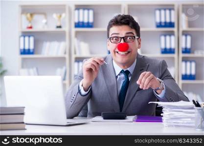 Clown businessman burning paper papers in the office