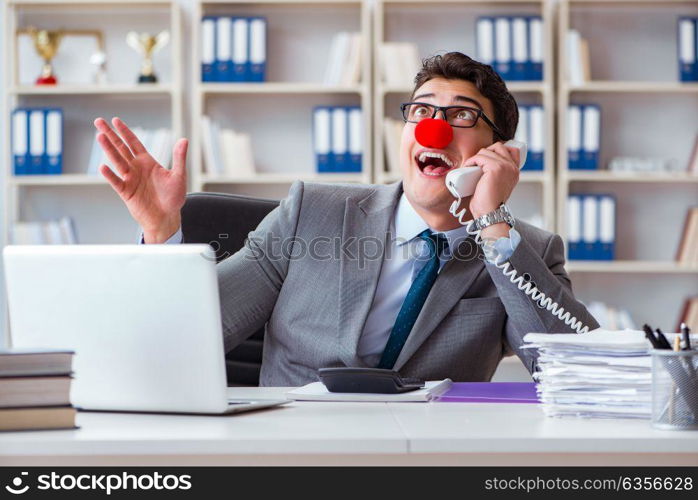 Clown businessman having fun in the office