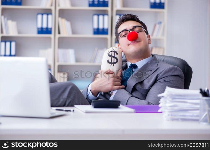 Clown businessman in the office with the a money sack