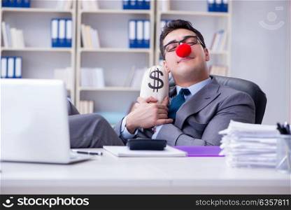 Clown businessman in the office with the a money sack
