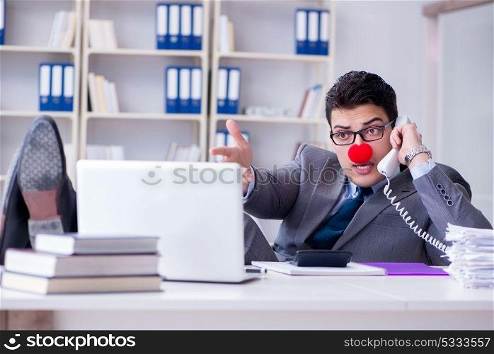 Clown businessman talking on phone working in office