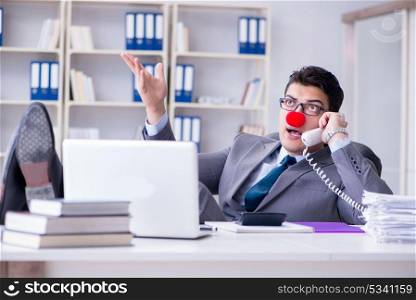 Clown businessman talking on phone working in office