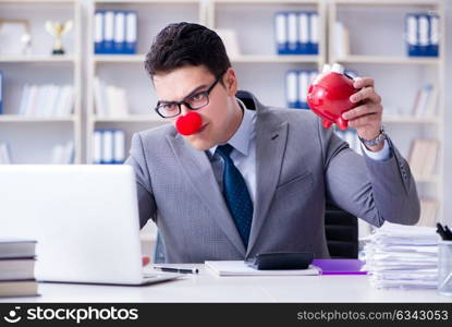 Clown businessman with piggy bank doing accounting