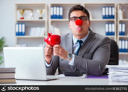 Clown businessman with piggy bank doing accounting