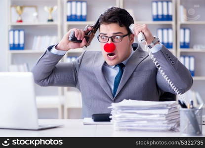 Clown businessman working in the office angry frustrated with a . Clown businessman working in the office angry frustrated with a gun