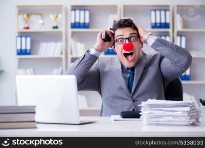 Clown businessman working in the office angry frustrated with a . Clown businessman working in the office angry frustrated with a gun