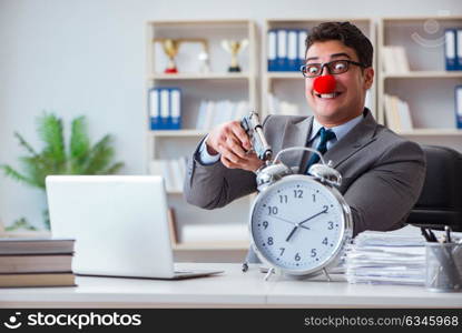 Clown businessman working in the office angry frustrated with a . Clown businessman working in the office angry frustrated with a gun