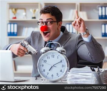 Clown businessman working in the office angry frustrated with a gun. Clown businessman working in the office angry frustrated with a