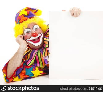 Clown lying on his side holding a blank white sign.