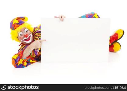Clown lying on the ground holding a blank white sign. Full body isolated on white.