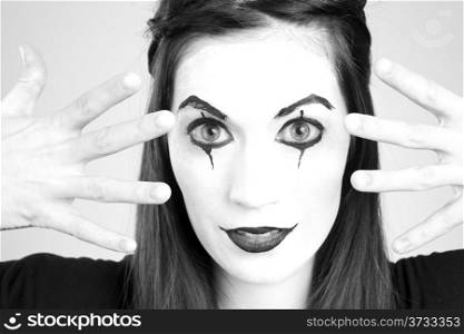Clown Mime in Whiteface Looking through her fingers