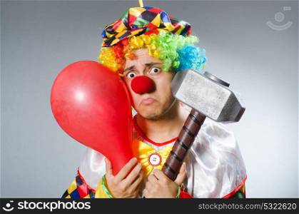 Clown with a hammer grey background isolated