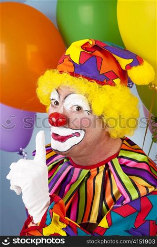 Clown with a secret, holding his finger to his lips.