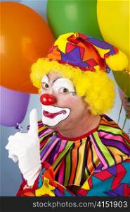 Clown with a secret, holding his finger to his lips.