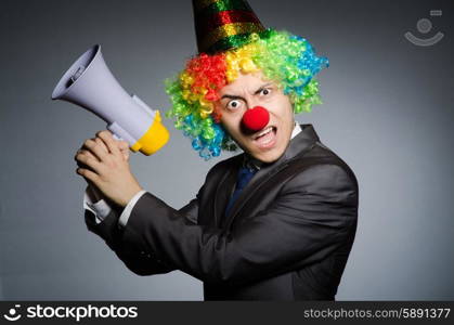 Clown with loudspeaker in funny concept