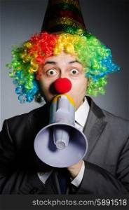 Clown with loudspeaker in funny concept