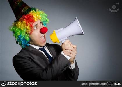Clown with loudspeaker in funny concept