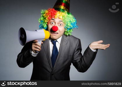 Clown with loudspeaker in funny concept