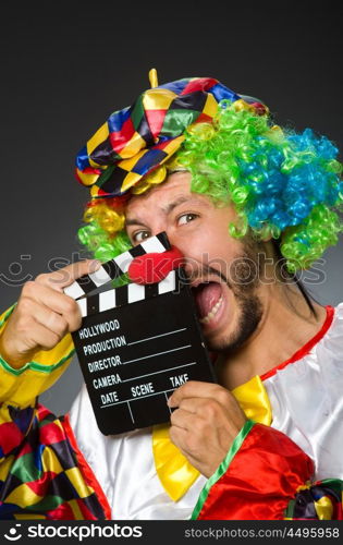 Clown with movie clapper board