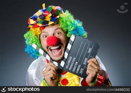 Clown with movie clapper board