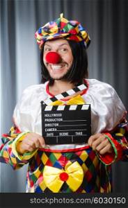 Clown with movie clapper board