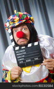 Clown with movie clapper board