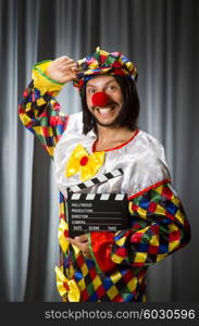 Clown with movie clapper board