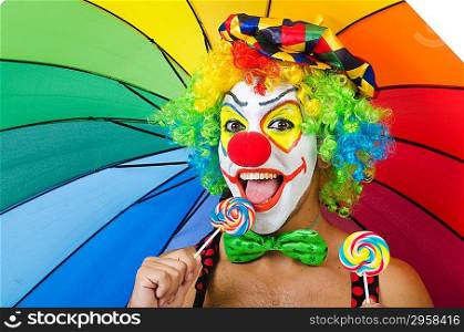 Clown with umbrella and lollypop