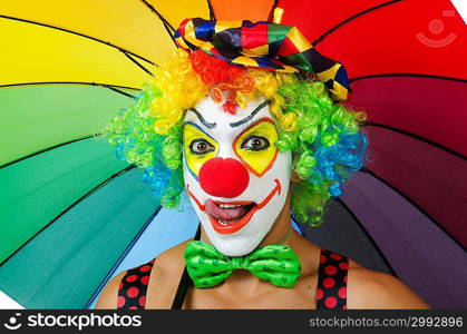 Clown with umbrella isolated on white