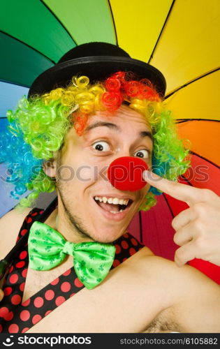 Clown with umbrella isolated on white