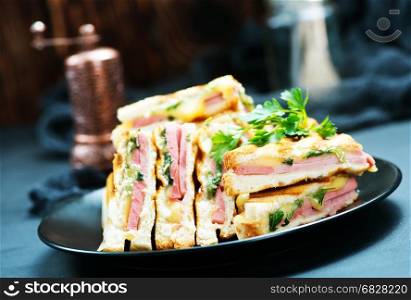 club sandwiches on plate and on a table