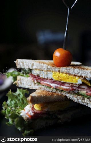 club sandwiches on wood background with mystic light