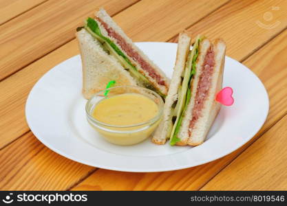 Club sandwiches with dip sauce on the plate. Club sandwiches