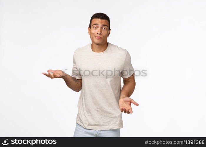 Clueless handsome young hispanic muscular man in casual t-shirt, shrugging, spread arms sideways, smirk and look indecisive, dont know how solve situation, standing puzzled and confused.. Clueless handsome young hispanic muscular man in casual t-shirt, shrugging, spread arms sideways, smirk and look indecisive, dont know how solve situation, standing puzzled and confused