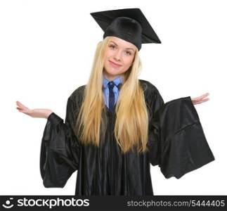 Clueless young woman in graduation gown shrugging shoulders
