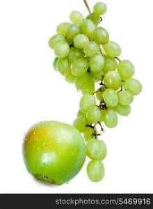 Cluster of grapes in water drops and apple