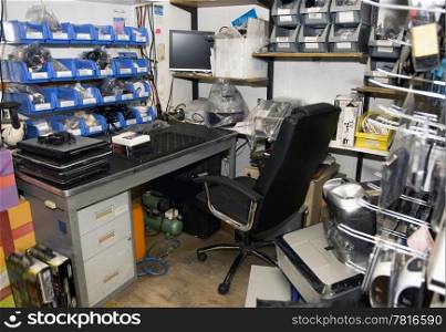 Cluttered and untidy computer room of a computer repair shop