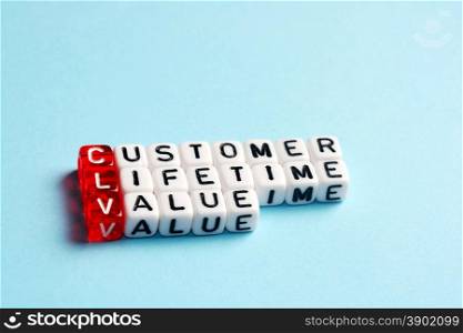 CLV Customer Lifetime Value written on dices on blue background