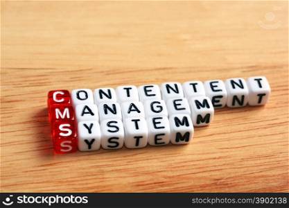 CMS Content Management System written on dices on wooden background