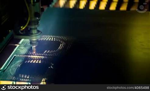 CNC Laser cutting of metal, modern industrial technology. Small depth of field.
