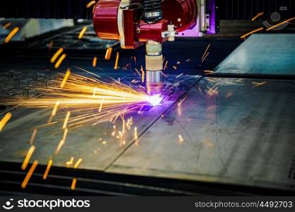 CNC Laser plasma cutting of metal, modern industrial technology. . Small depth of field. Warning - authentic shooting in challenging conditions. A little bit grain and maybe blurred.