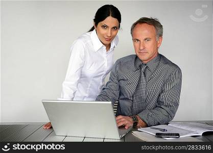 Co-workers in front of laptop