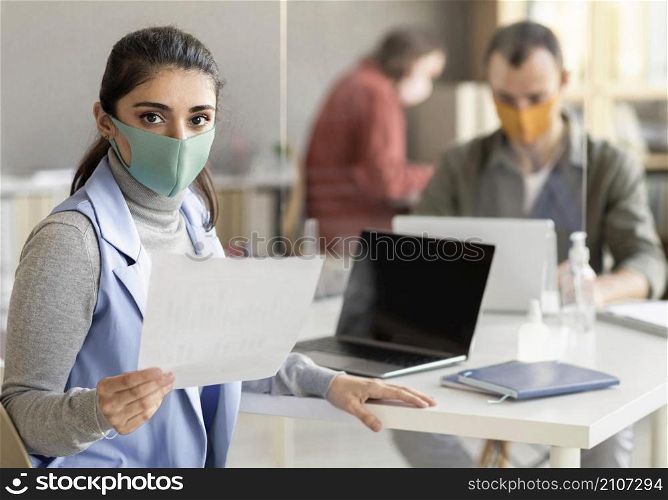 co workers wearing face mask office
