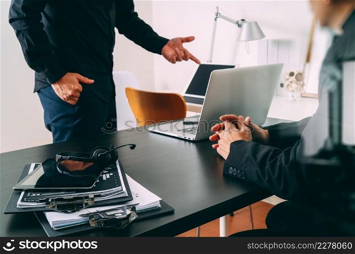 co working meeting,two businessman using VOIP headset with latop computer on desk in modern office as call center and customer service help desk concept